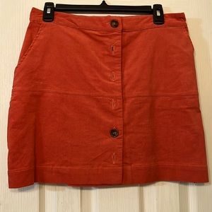 New with tags. Size large burnt orange corduroy skirt. Button front with pockets
